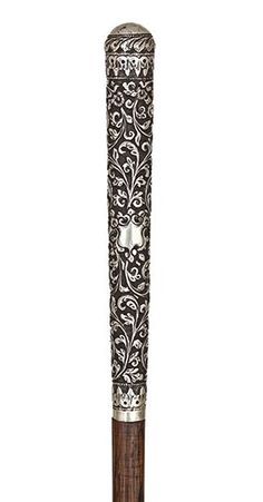 an ornate wooden and metal pole on a white background