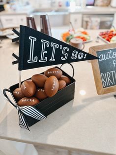 a football themed birthday party with black and white decorations, chalkboard pennants and chocolate eggs in a box