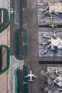 an aerial view of airplanes parked on the tarmac