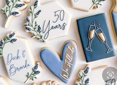 decorated cookies with the words 50 years and two glasses of champagne on them are arranged next to each other