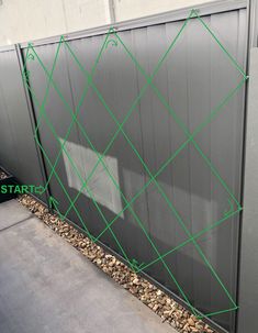 the side of a building with green lines on it