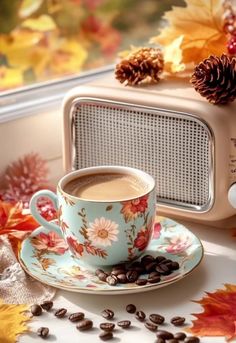 a cup of coffee sitting on top of a saucer next to a toaster