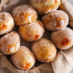 powdered sugar covered donuts in a basket