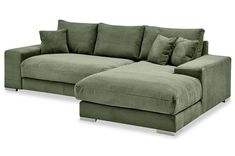 a green sectional sofa with pillows on it's back and the seat folded down