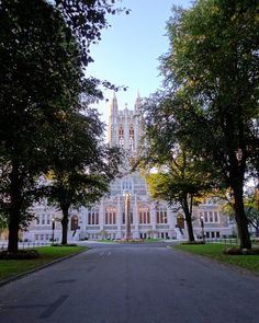 a large white building surrounded by trees and grass