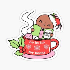 a baby in a christmas cup reading a book with holly leaves on the side sticker