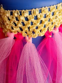 pink and yellow crocheted doily on top of a cake