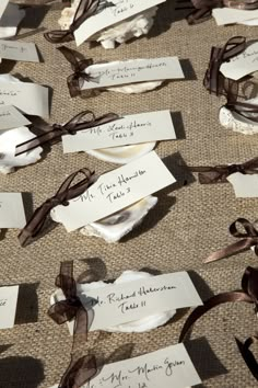 several pieces of paper that have been tied together with brown ribbons and tags on them