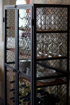 a metal cabinet filled with lots of plates and glasses on top of it's sides