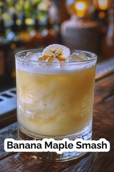 a banana maple smash cocktail in a glass on a table with the words, banana maple smash