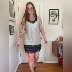 This is a great 1990s vintage party dress. Made of a silver sparkly lurex fabric covered in mirrored sequins! It has black fringe along the neckline and bottom.  Sleeveless and mini length, the dress pulls on over the head. Overall in good vintage condition with no major flaws to note.  No size tags - approximately a large. Would make a great NYE dress! Sequin Sleeveless Flapper Dress, Silver V-neck Mini Dress For Holiday, Vintage Sleeveless Sequin Flapper Dress, V-neck Sequined Flapper Dress For Party Season, Silver Embellished V-neck Mini Dress, Disco Jumpsuit, Vintage Party Dress, Lurex Fabric, Pucci Vintage