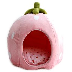 a pink cat bed with polka dots on it