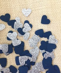 blue and silver heart confetti on a burlocked cloth with glitter hearts