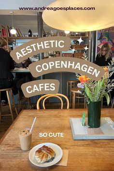 a wooden table topped with a plate of food next to a vase filled with flowers