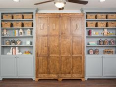 a large wooden cabinet sitting in the middle of a room with lots of bookshelves