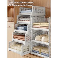 an organized closet with clothes and linens on shelves in white metal mesh bins