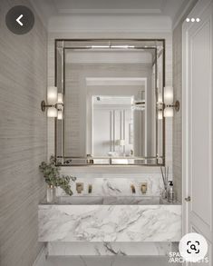 a bathroom with marble counter tops and white walls