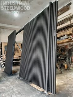 an industrial steel door is open in a workshop