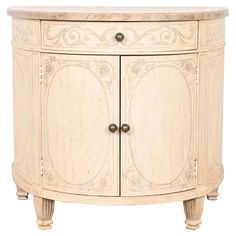 an antique style cabinet with two doors and carvings on the front, in white wood