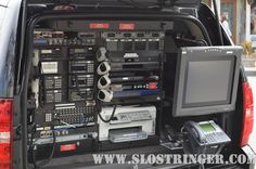 the back end of a van with electronic equipment in its cargo compartment and electronics attached to it