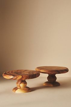 two wooden stools sitting next to each other