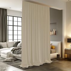 a living room with a white couch and curtains