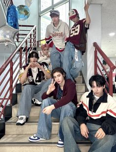 a group of young men sitting on top of stairs