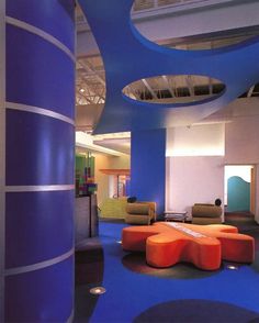 an office lobby with blue and orange furniture