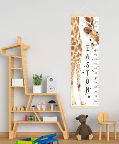 a giraffe standing next to a wooden shelf with a stuffed animal on it