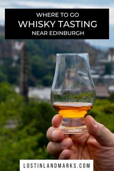 a person holding up a wine glass with the words where to go whisky tasting near edinburgh