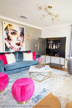 a living room filled with furniture and a painting on the wall