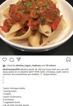 a white bowl filled with pasta and sauce on top of a black table next to an instagram post