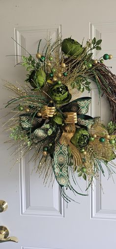 a wreath on the front door is decorated with green and gold decorations