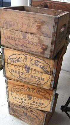 an old wooden box sitting on top of a white tile floor next to a planter