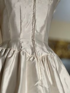 the back of a white wedding dress on display