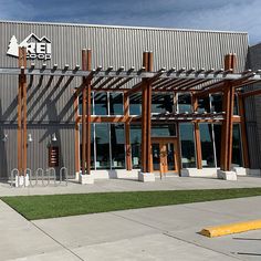 a building with an awning on the side of it and grass in front of it