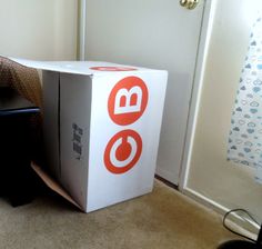 an open box sitting on the floor next to a chair