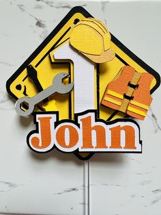 there is a sign that says john 1 with construction tools on it and the number one