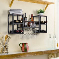 a wall mounted wine rack with bottles and glasses on it next to a shelf filled with utensils