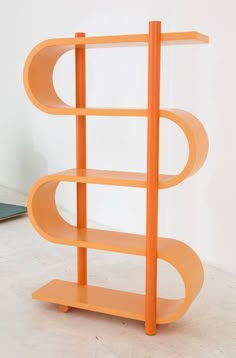 an orange shelf sitting on top of a white floor