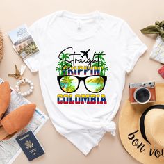 a t - shirt with the words trippin's columbia on it and sunglasses