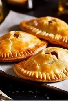 three pies sitting on top of a piece of paper