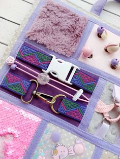 there are many different items on this patchwork bag, including scissors and hair clips