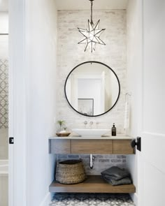 a bathroom with a sink, mirror and tiled floor