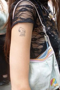 a woman with a small tattoo on her arm