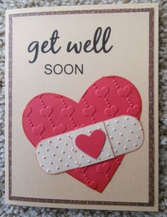 a card that says get well soon with a red heart and white ribbon on it