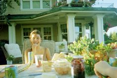 a woman sitting at a table with food in front of her