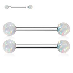 two white opalite balls are attached to the back of a pair of surgical barbells