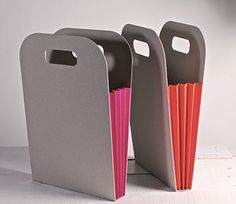 three gray and pink folders sitting next to each other on top of a table