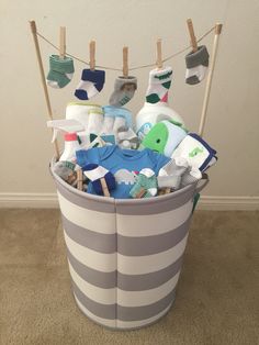 a basket filled with baby items hanging from clothes pins